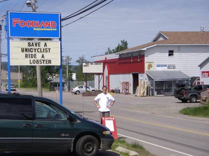Two of the many signs welcoming unicyclists to Newfoundland (the one in the background says "Ride the Lobster Baby!")