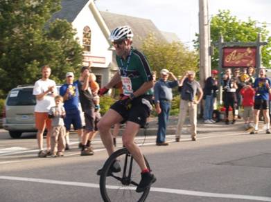 Jeff riding triumphantly to the finish line in Baddeck.